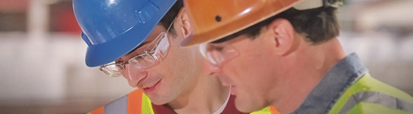 two men in hard hats on construction site