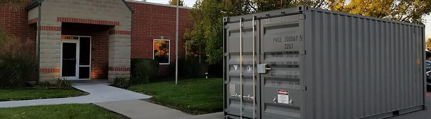 Storage container sitting in front of a building