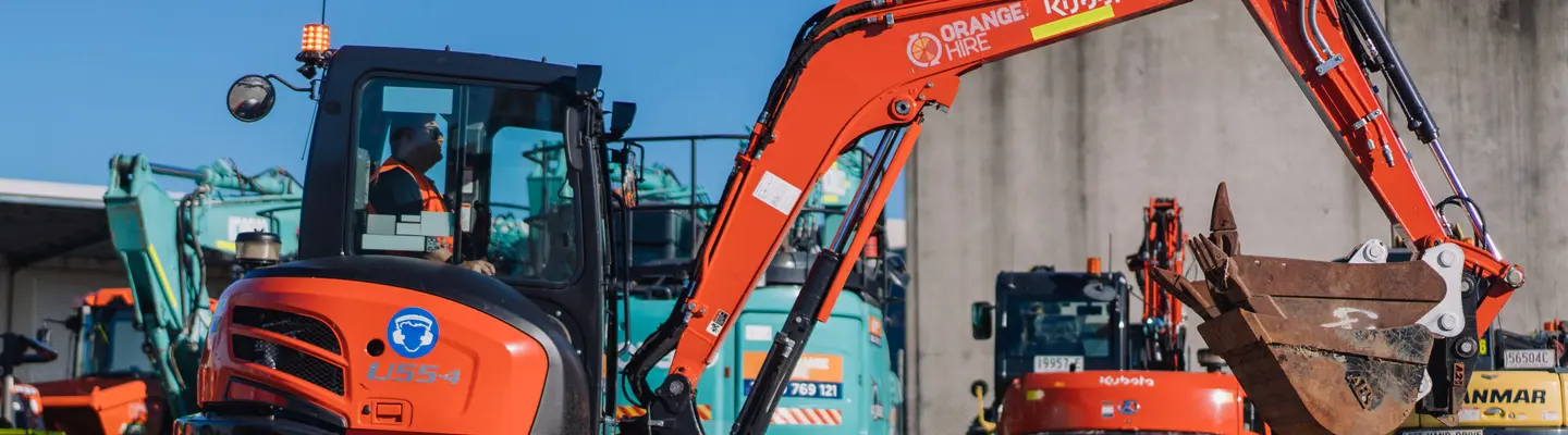 Technician performing maintenance on construction equipment to ensure safe and reliable operation at work sites.