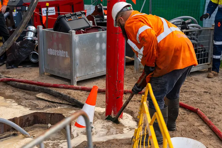 Worker with dewatering solution on site