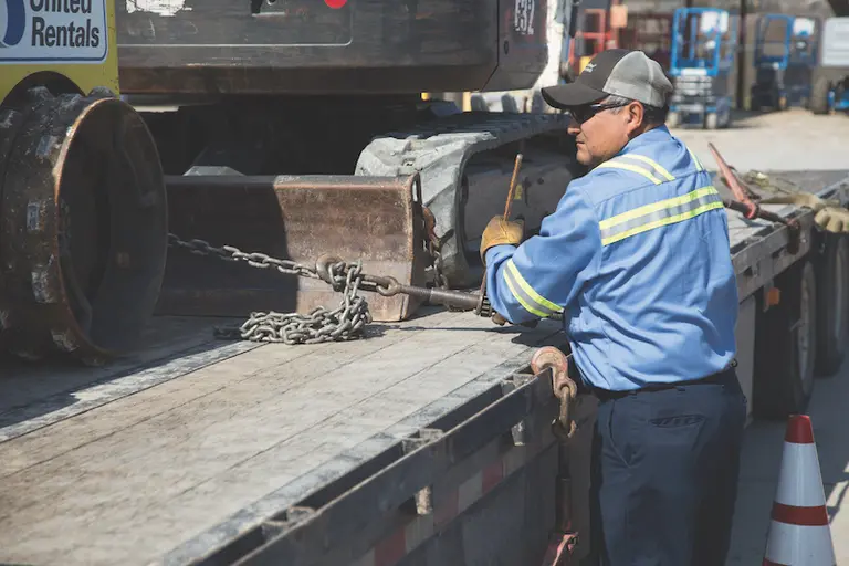 Man Loading Equipment on Trailer