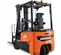 Rear view of an orange and black Doosan electric warehouse forklift with an open operator cabin and black forks.
