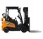 Side view of an orange and black Doosan warehouse forklift with a black mast and forks, open cabin and cushion tires.