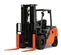 Front angled view of an orange and black Toyota warehouse forklift with a black mast, orange forks and an open cabin.