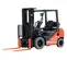 Front angled view of an orange and black Toyota warehouse forklift with a black mast, orange forks and an open cabin.