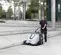 White and black Nilfisk 36 inch gas powered Walk-behind Sweeper