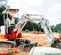 White, red and gray TAKEUCHI 4,000-5,000 lb. Mini Excavator, Zero Tail Swing