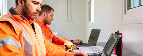Man in mobile storage container working on computer