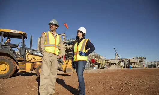 man and woman on construction site in PPE 