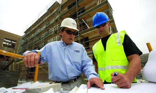 two men in hard hats on construction site