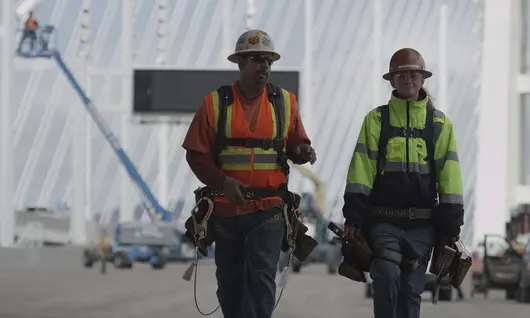 two men in hard hats on construction site