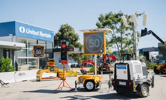 Traffic Management: A range of traffic management equipment that includes Tripod Mounted Traffic Lights, VMS Board – Variable Message Signs, Trailer Mounted Lighting Tower and Deltabloc Concrete Barriers (in the background).                                                                                                                                                                                     Barriers: Lo-Ro Water Filled Barriers stacked up at a United Rentals yard