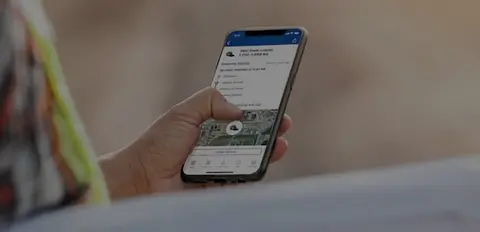 Mobile App held in hand by worker