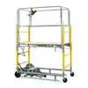 Side view of a silver and yellow mobile scaffold with guardrails.