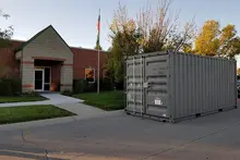 Storage container sitting in front of a building