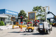 Traffic Management: A range of traffic management equipment that includes Tripod Mounted Traffic Lights, VMS Board – Variable Message Signs, Trailer Mounted Lighting Tower and Deltabloc Concrete Barriers (in the background).                                                                                                                                                                                     Barriers: Lo-Ro Water Filled Barriers stacked up at a United Rentals yard