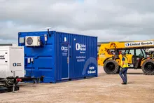 Worker walking to a supplies on demand container